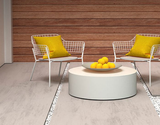 Two chairs and the Blinde Design L1 concrete coffee table in the colour bone