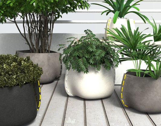 View of the Stitch concrete planters in different sizes and different colours: graphite, natural and bone