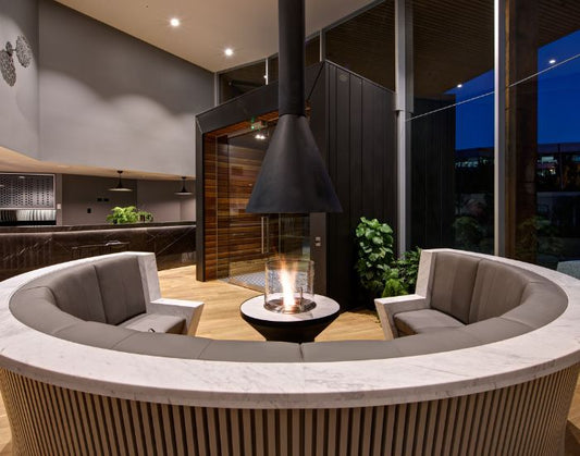 View of the EcoSmart Fire AB3 bioethanol burner in the colour black next to a booth