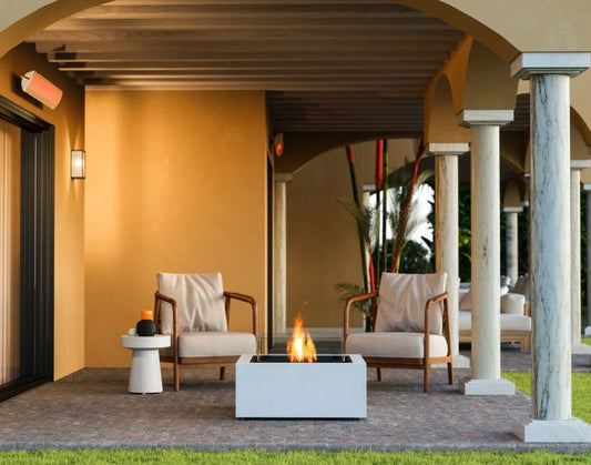 View of the EcoSmart Fire base 30 bioethanol Fire Pit Table in the colour bone next to two chairs