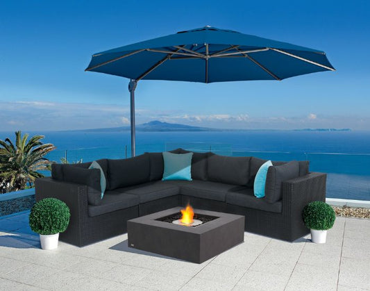View of the sea side and the EcoSmart Fire Base 40 Bioethanol Fire Pit Table in the colour graphite with a stainless steel burner