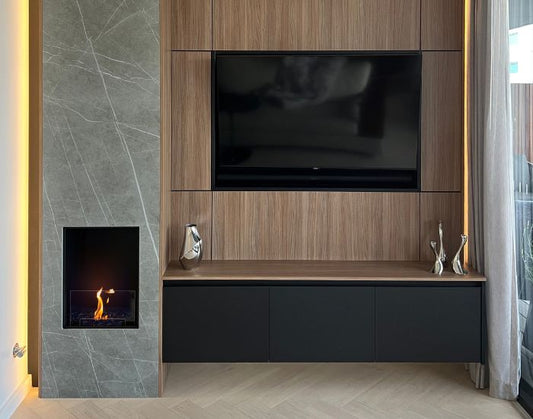 View of a living room with the EcoSmart Fire Flex 18SS Single Sided Fireplace Insert next to a television 
