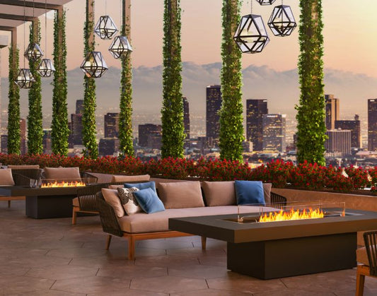 View of skyscrapers and two EcoSmart Fire Gin 90 (Chat) bioethanol Fire Pit Tables in the colour graphite