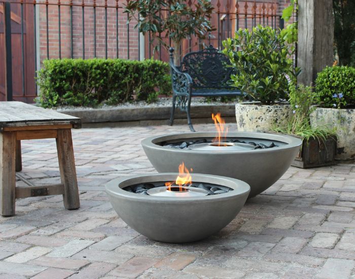 View of a garden with the EcoSmart Fire Mix 600 and 850 Bioethanol Fire Pit Bowl in the colour natural