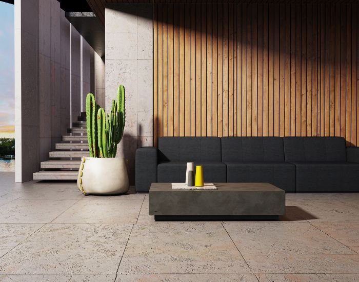 View of the Blinde Design Stitch 100 concrete planter in the colour bone next to a sofa